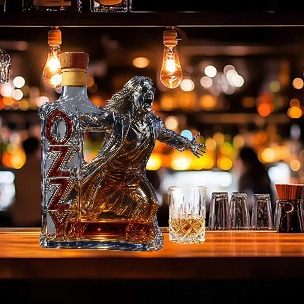 Sculpted Ozzy Osbourne bottle with wooden cork top and whiskey glass on bar. 