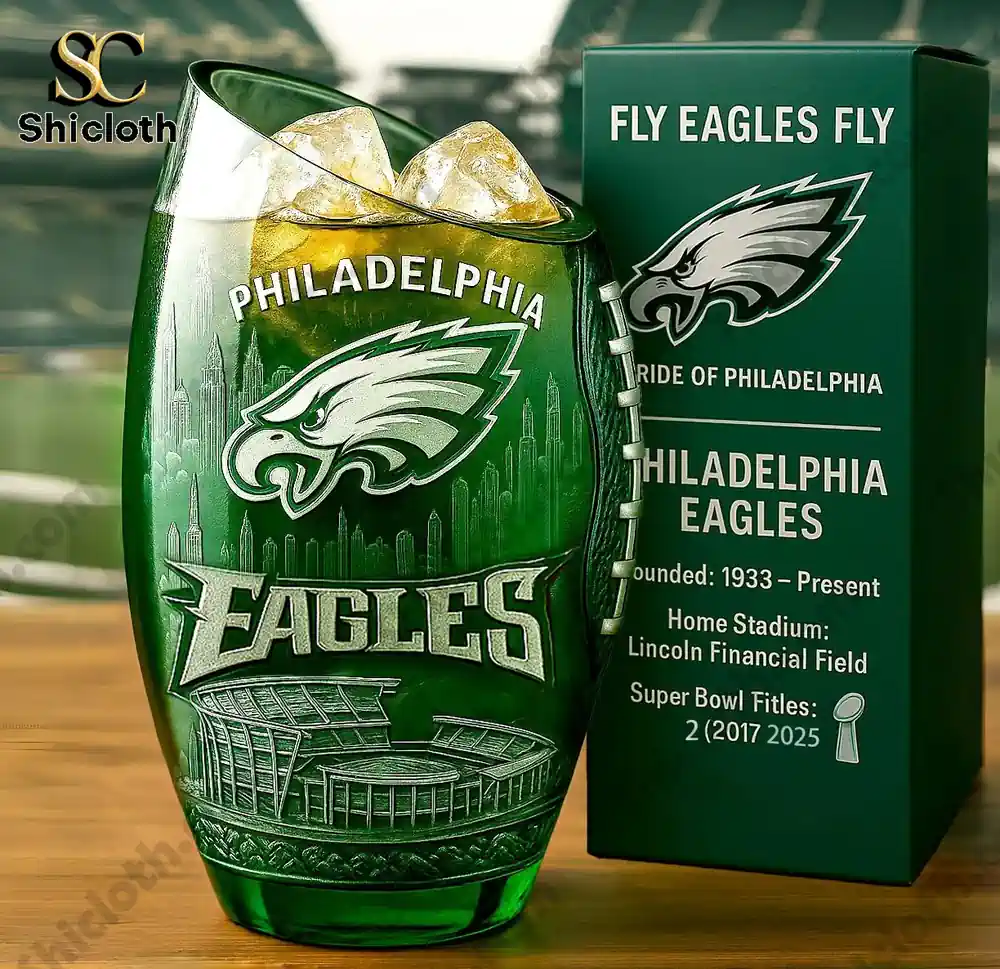 Green whiskey glass with Philadelphia Eagles logo and Lincoln Financial Field design next to a matching Eagles box.