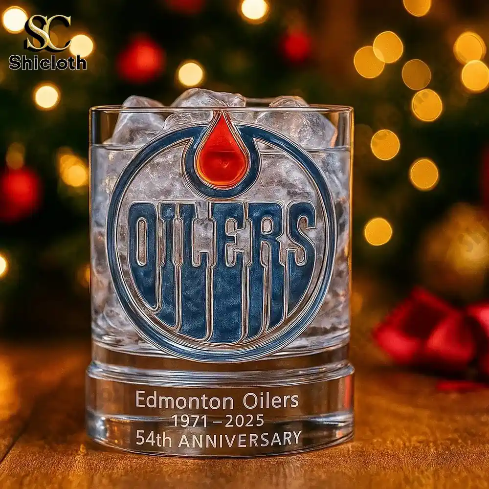 Edmonton Oilers whiskey glass 54th anniversary displayed with holiday background.