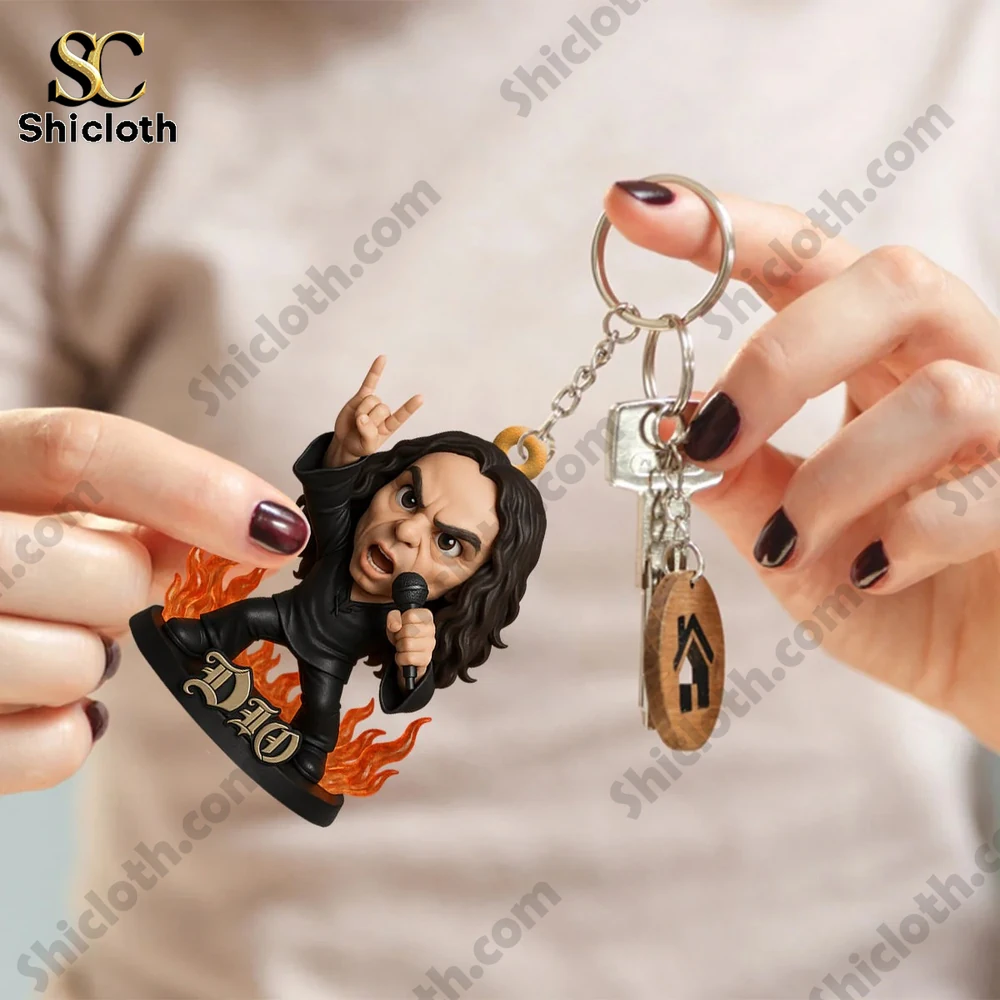 Keychain figure of a cartoon rock singer with flames and microphone