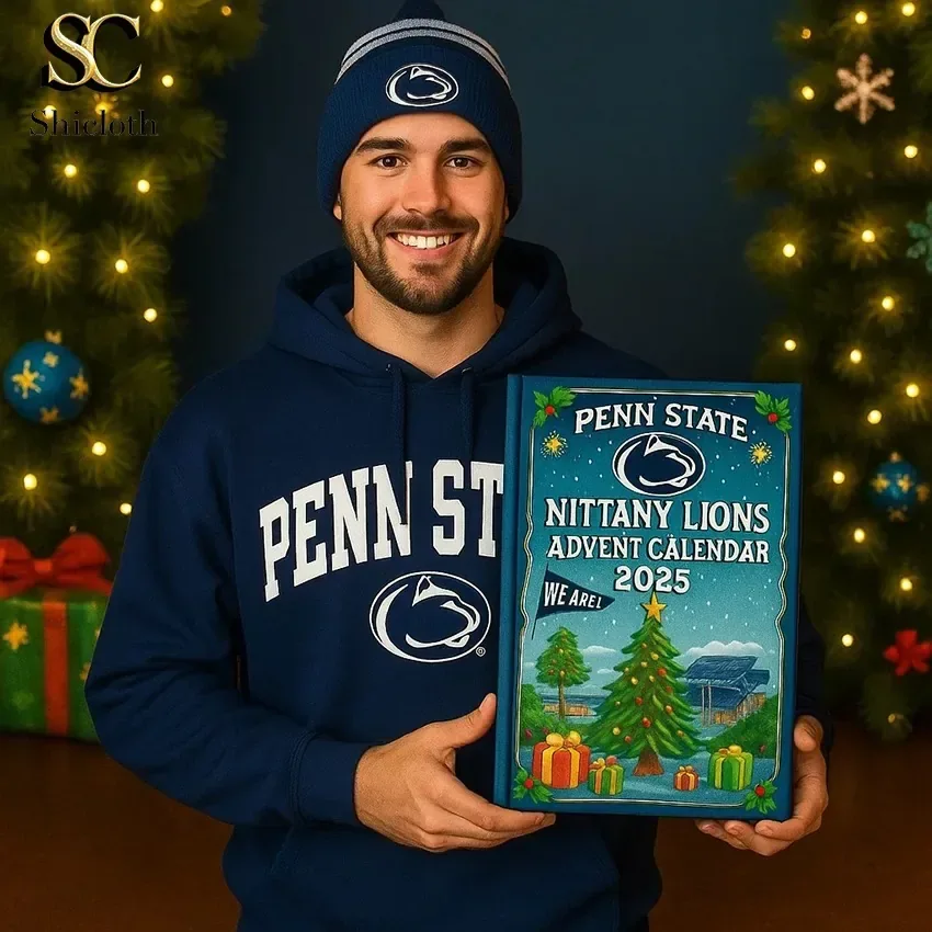 Man in Penn State apparel holding a Nittany Lions advent calendar box in a holiday setting.