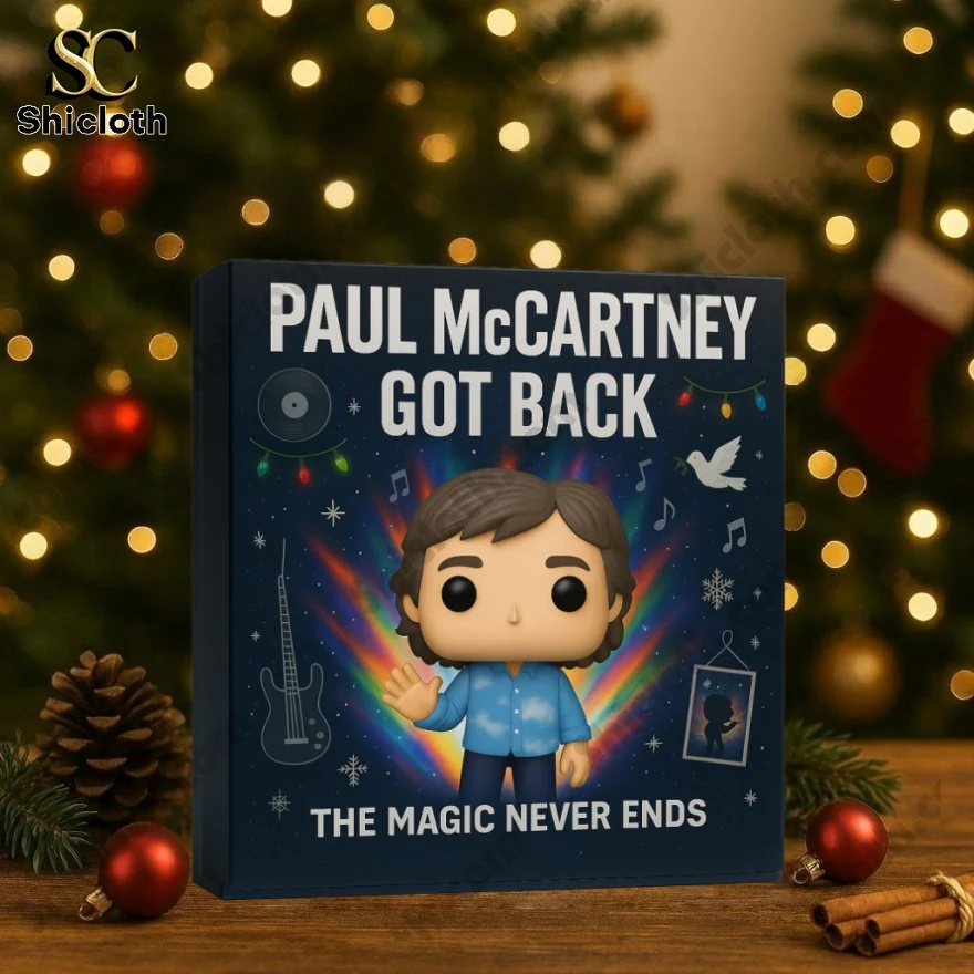 A Paul McCartney Got Back advent calendar placed on a wooden table with Christmas decorations.