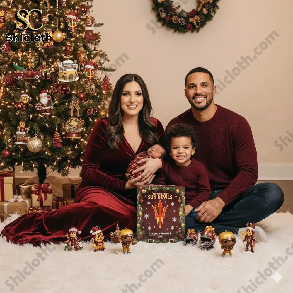 A happy family poses beside a Christmas tree decorated with Arizona State Sun Devils ornaments and a 2025 Advent Calendar box.