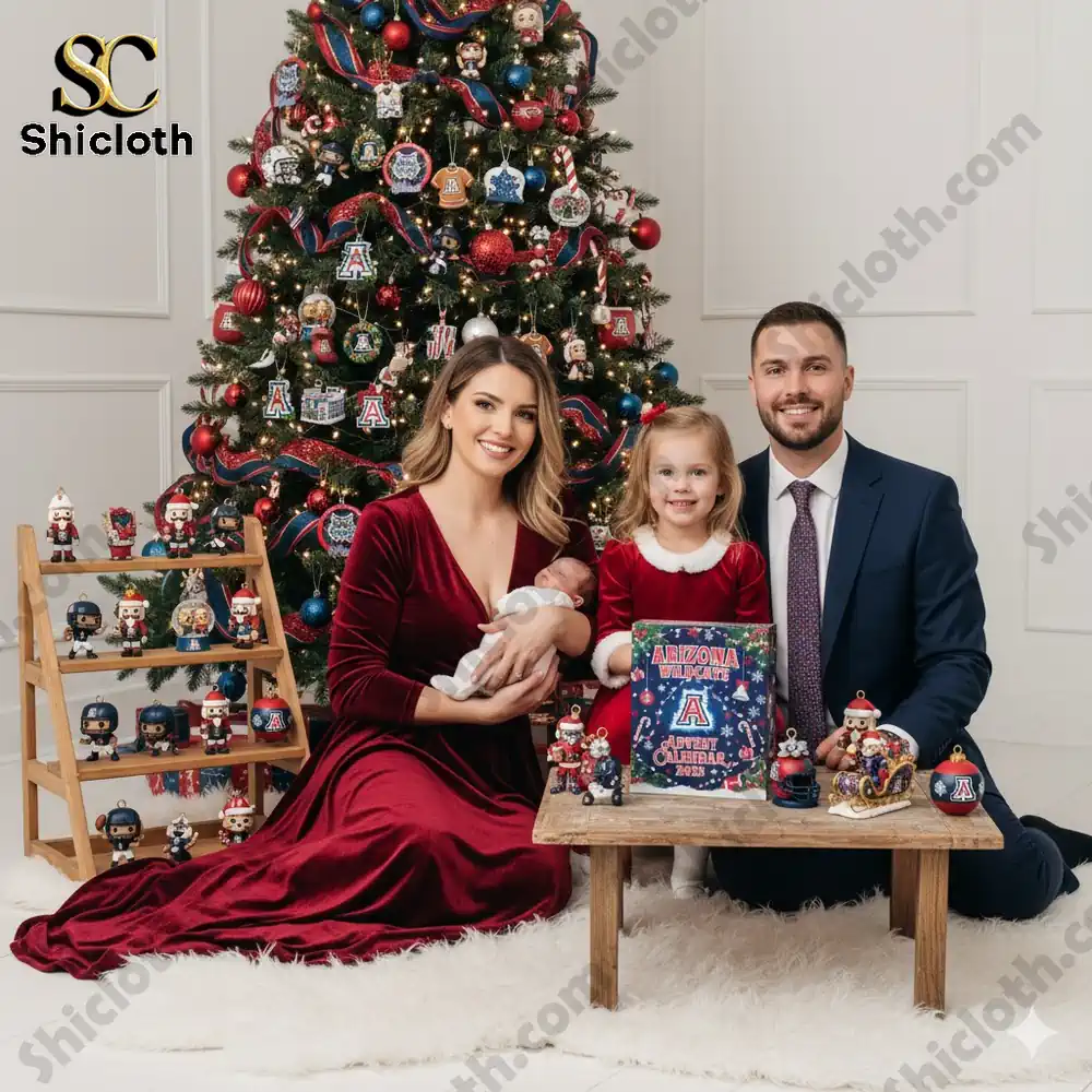 A family posing with the Arizona Wildcats Advent Calendar 2025 next to a Christmas tree decorated with team ornaments!