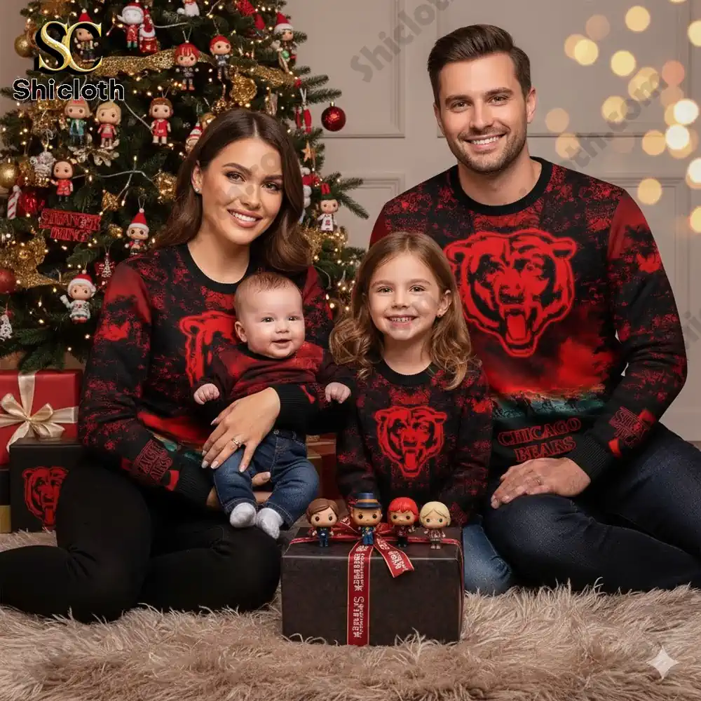 A smiling family wearing matching Chicago Bears and Stranger Things Christmas sweaters sitting by a decorated Christmas tree with gifts.