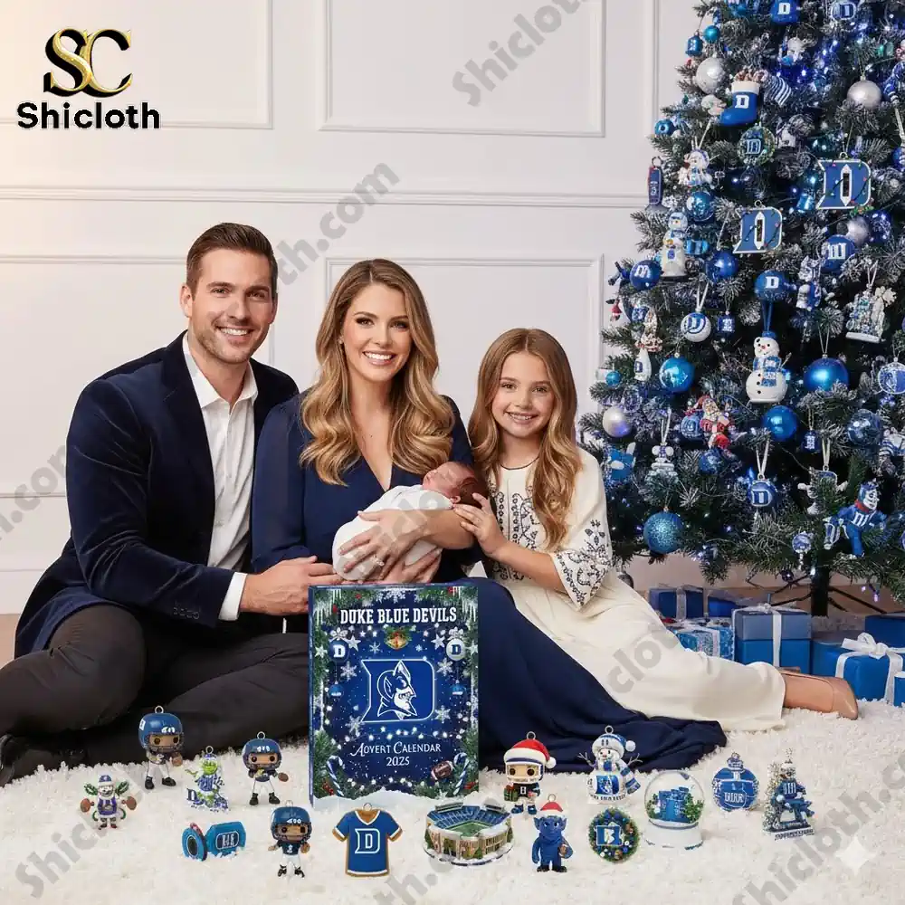 A smiling family poses beside a Christmas tree decorated in blue and white with a Duke Blue Devils 2025 Advent Calendar and themed ornaments!