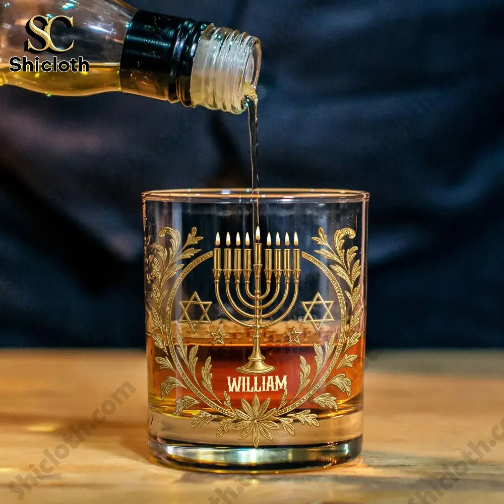 Happy Hanukkah Personalized Whiskey Glass 3 Pouring whiskey into a menorah themed glass labeled William.