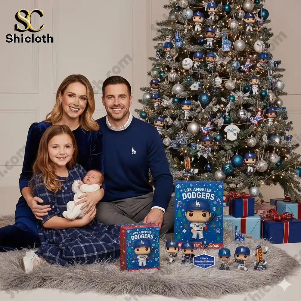 A family dressed in blue poses beside a Christmas tree decorated with Dodgers ornaments and Los Angeles Dodgers Advent Calendar 2025 boxes!