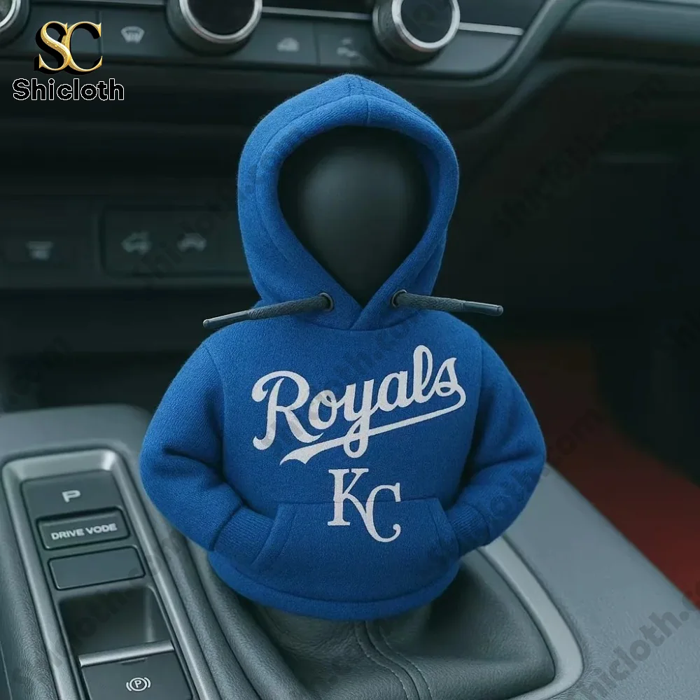 A car gear shift cover figure wearing a blue hoodie with the Royals baseball team logo inside a car by Shicloth!