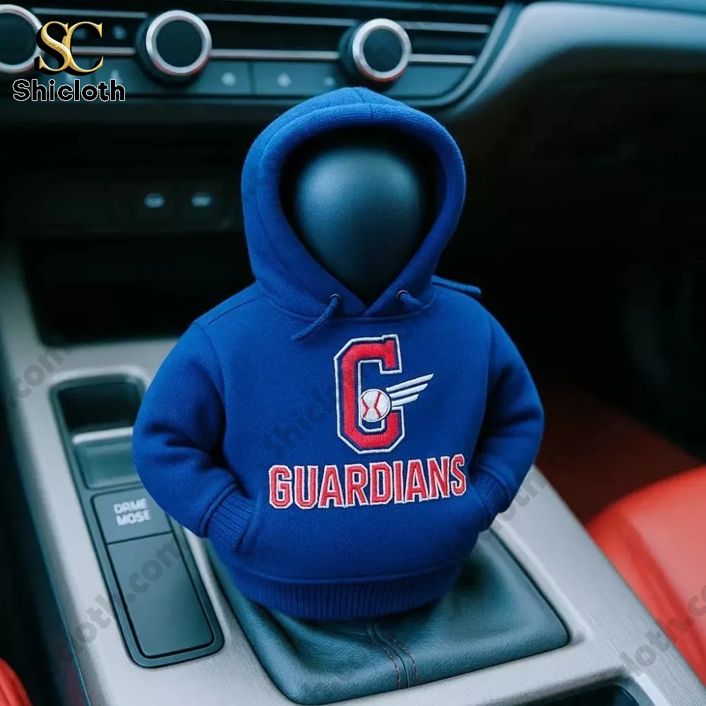 A car gear shift cover figure wearing a blue hoodie with the Guardians baseball team logo inside a vehicle by Shicloth!