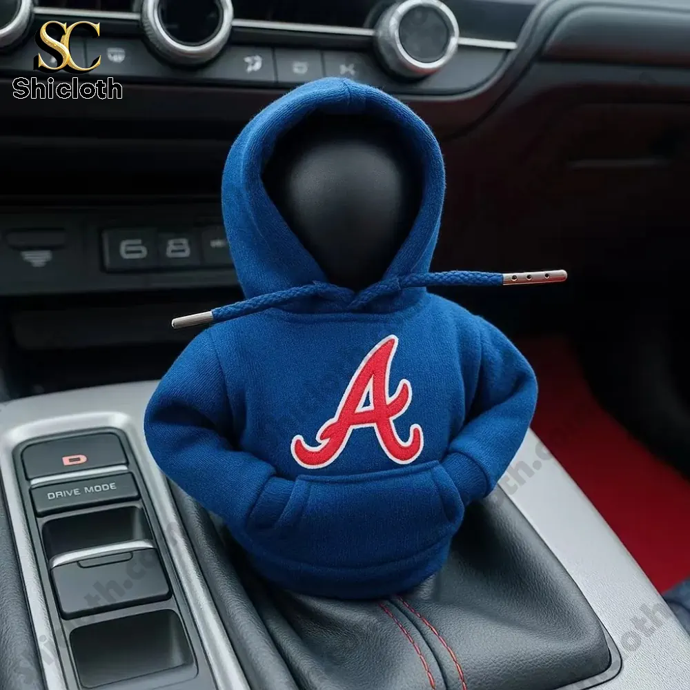 A car gear shift knob dressed in a blue hoodie with a red A baseball team logo inside a car!
