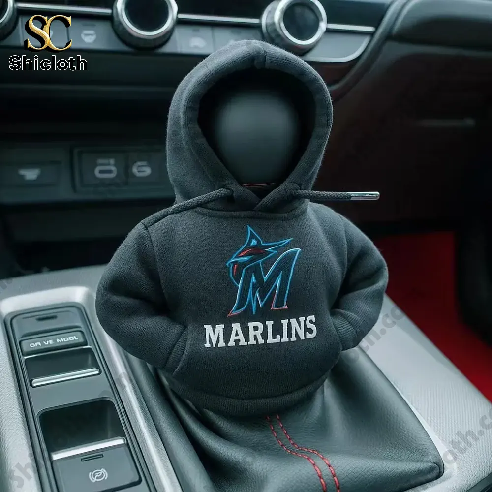 A black Miami Marlins hoodie cover on a car gear shift knob inside a car interior!
