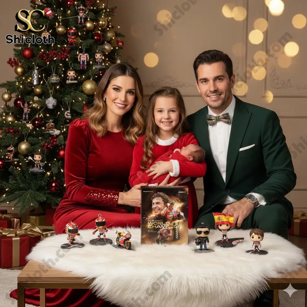 A smiling family sits by a Christmas tree with the 2025 MotoGP World Champion Advent Calendar and collectible mini figures on a table.
