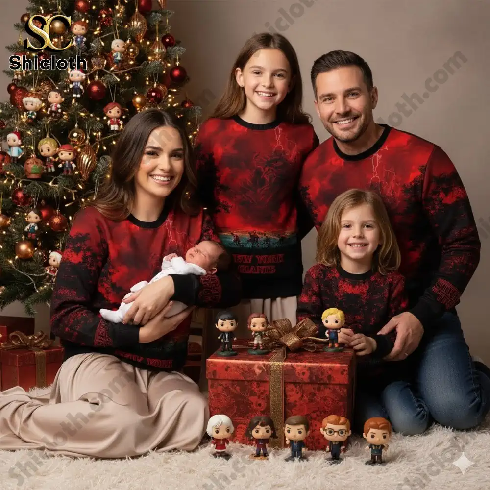 Family wearing matching New York Giants Christmas sweaters posing by a festive tree!