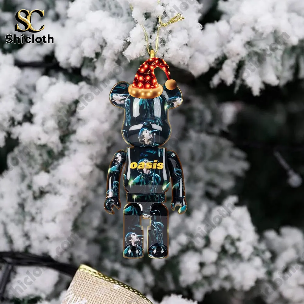 Oasis Band Premium Advent Calendar 2025 5 Oasis themed bear ornament with Christmas hat hanging on tree.