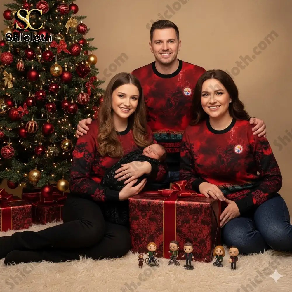 A family wearing matching Pittsburgh Steelers themed sweaters poses for a Christmas photo with a baby and gifts under a decorated tree.
