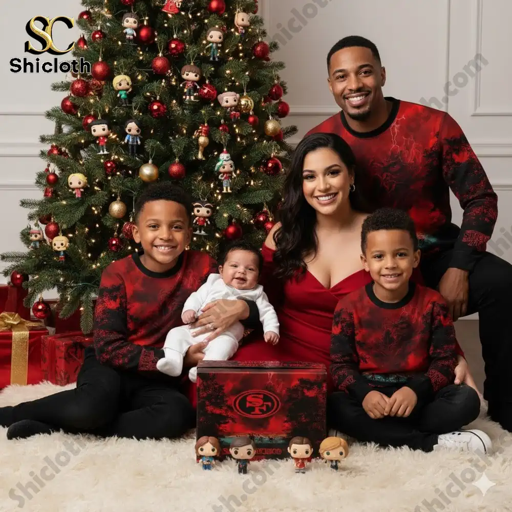 A family wearing matching red and black San Francisco 49ers Stranger Things sweaters poses for a Christmas photo beside a decorated tree!