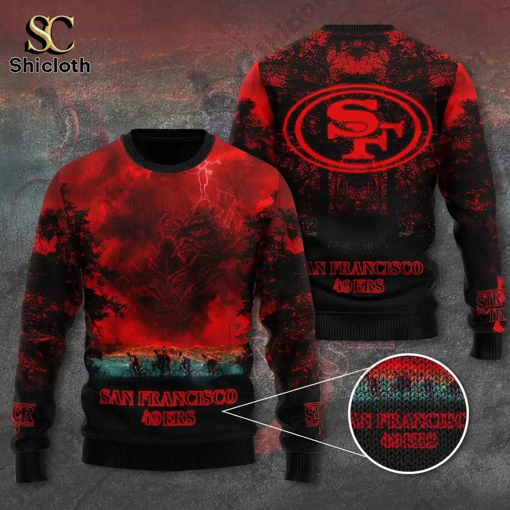 A detailed view of a red and black San Francisco 49ers sweater featuring Stranger Things inspired artwork with the team logo!