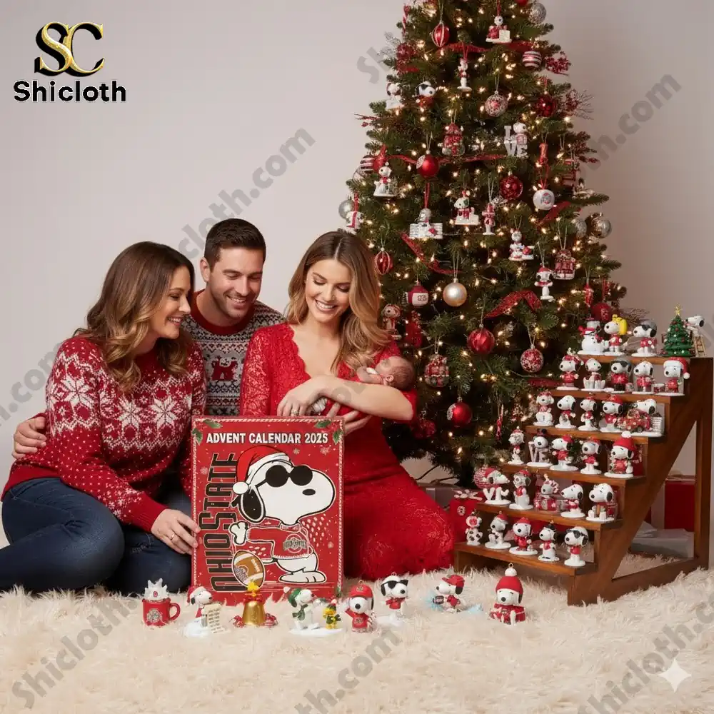 A happy family sitting near a Christmas tree with the Ohio State 2025 Advent Calendar box and Snoopy ornaments!