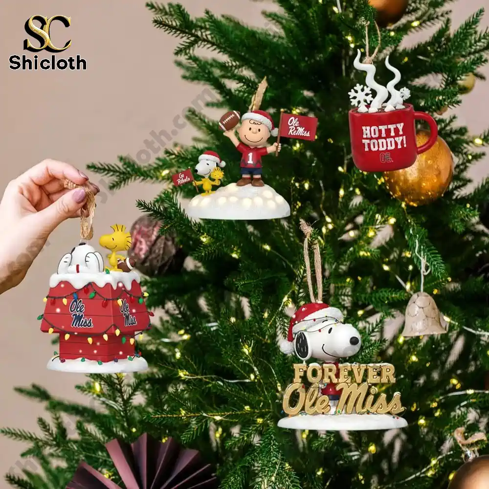 Close up of Snoopy and Ole Miss Rebels Christmas ornaments hanging on a decorated tree.