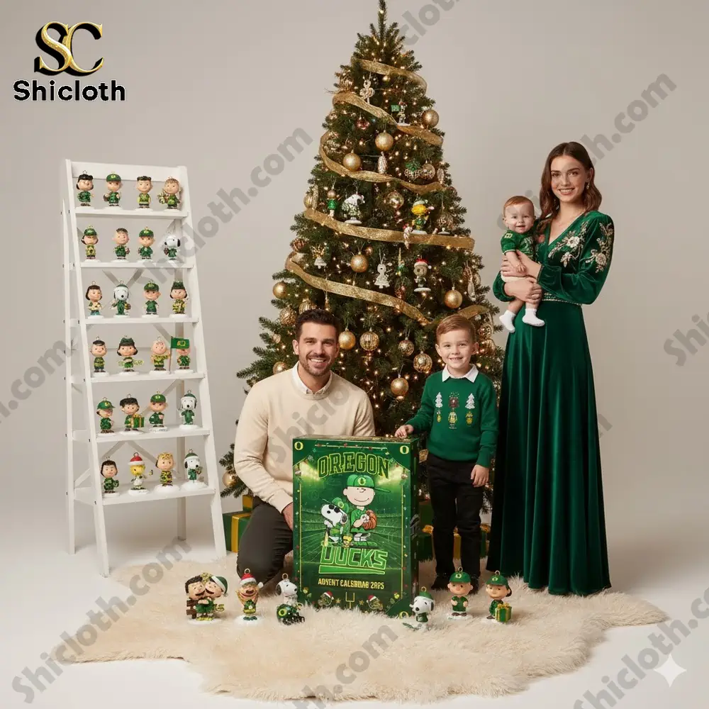 A family poses beside a Christmas tree with Oregon Ducks themed decorations and an advent calendar box.