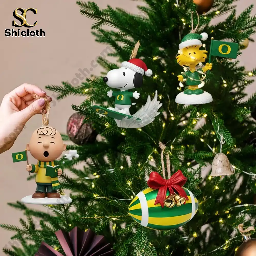 Close up of Oregon Ducks themed Christmas ornaments featuring Peanuts characters on a decorated tree.