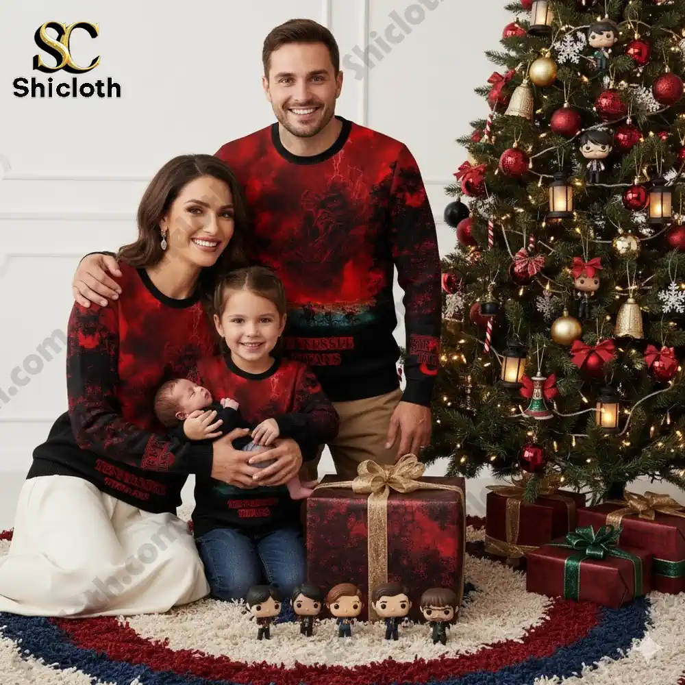 A family poses by a Christmas tree wearing Tennessee Titans Stranger Things themed sweaters.