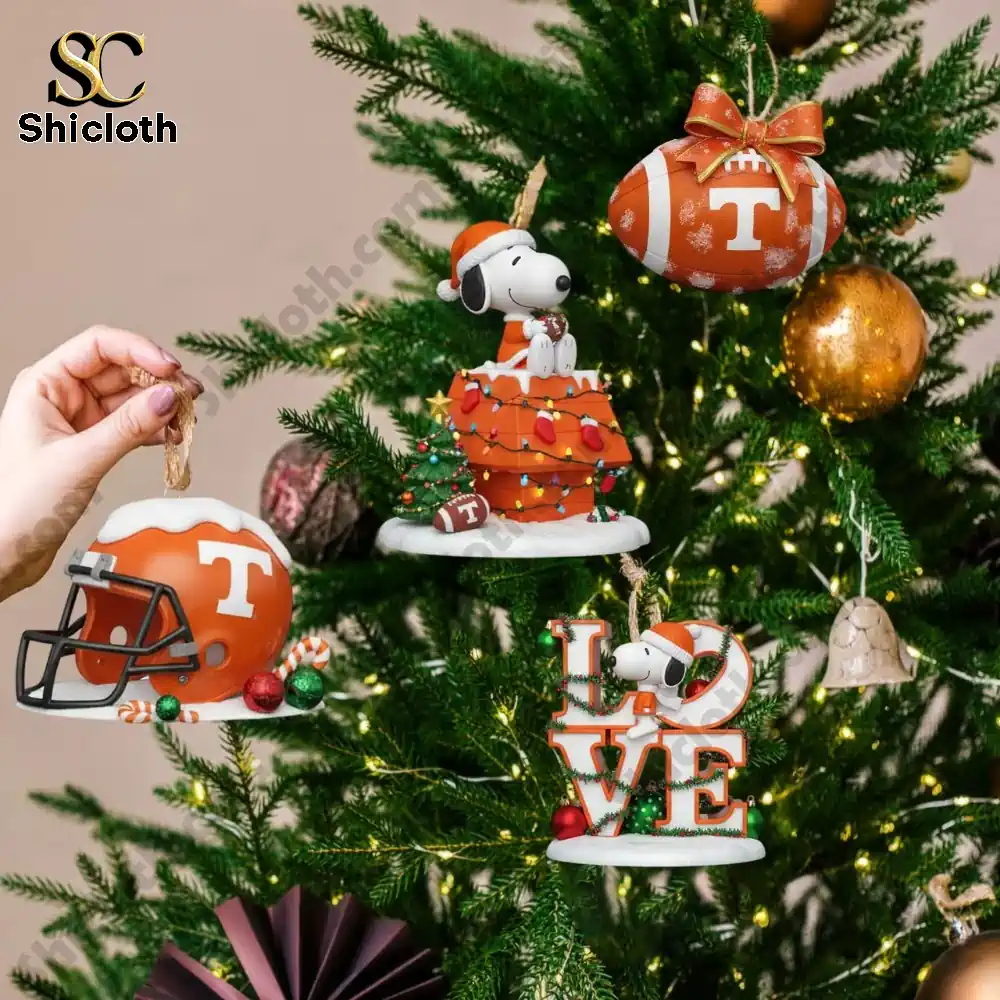 Close up of Tennessee Volunteers themed Christmas ornaments featuring Snoopy and football designs on a festive tree!