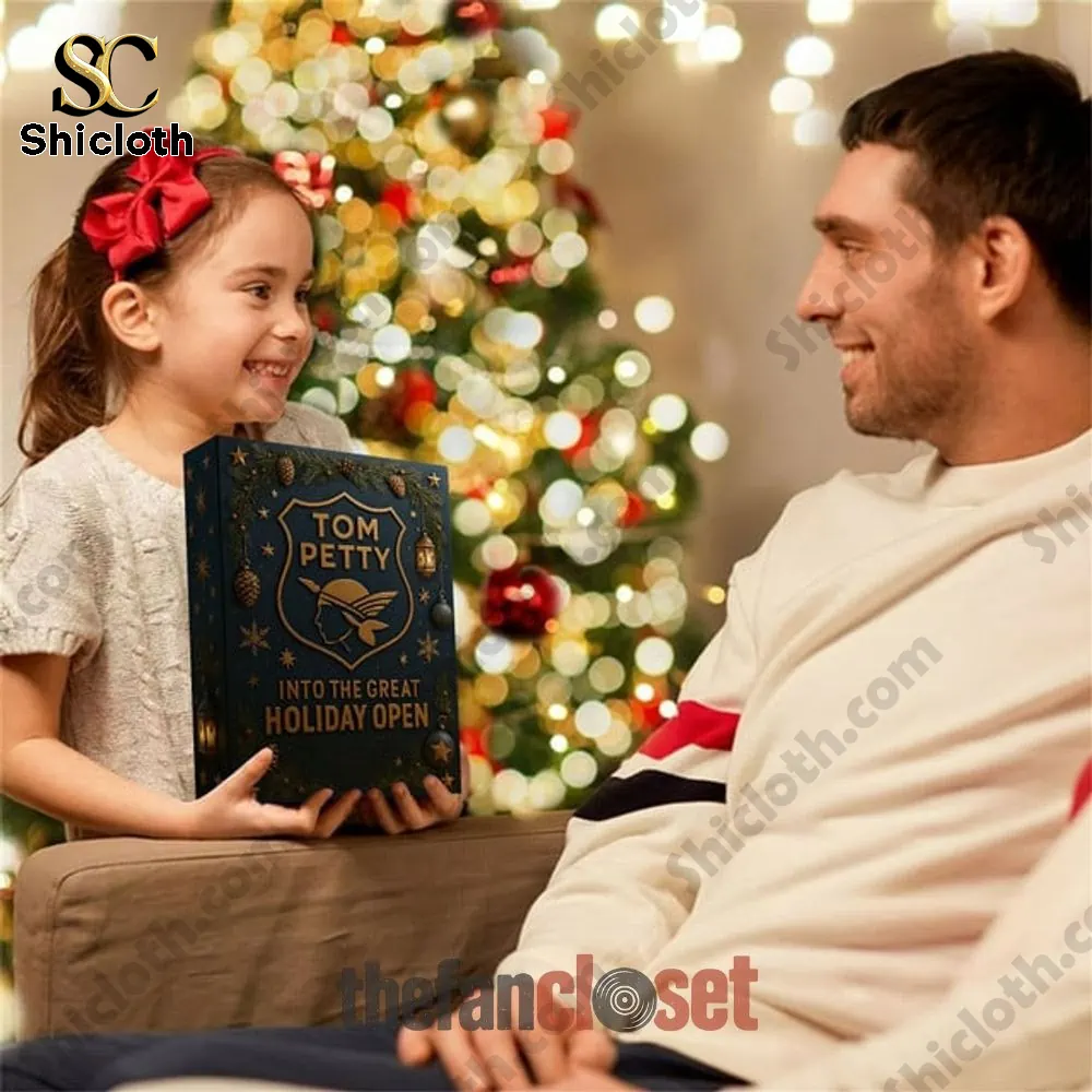 Tom Petty Into The Great Holiday Open Advent Calendar 2025 4 Smiling girl giving Tom Petty Into the Great Holiday Open Advent Calendar to her father by Christmas tree.