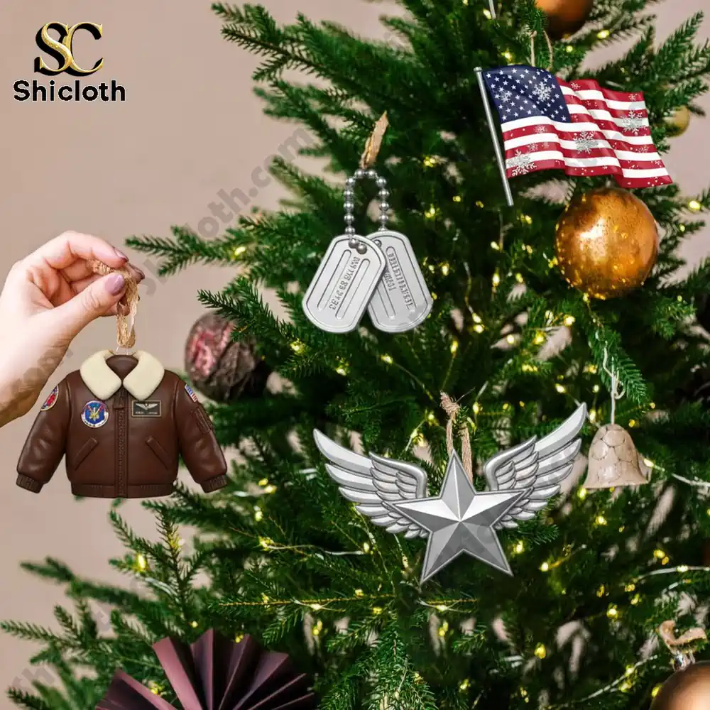 Top Gun Premium Advent Calendar 2025 3 Top Gun themed ornaments including a pilot jacket, dog tags, wings, and a flag hanging on a Christmas tree.