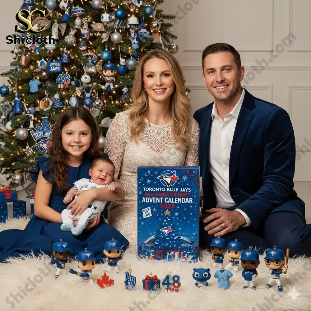A family poses by a Christmas tree with a Toronto Blue Jays 2025 Advent calendar and themed ornaments.