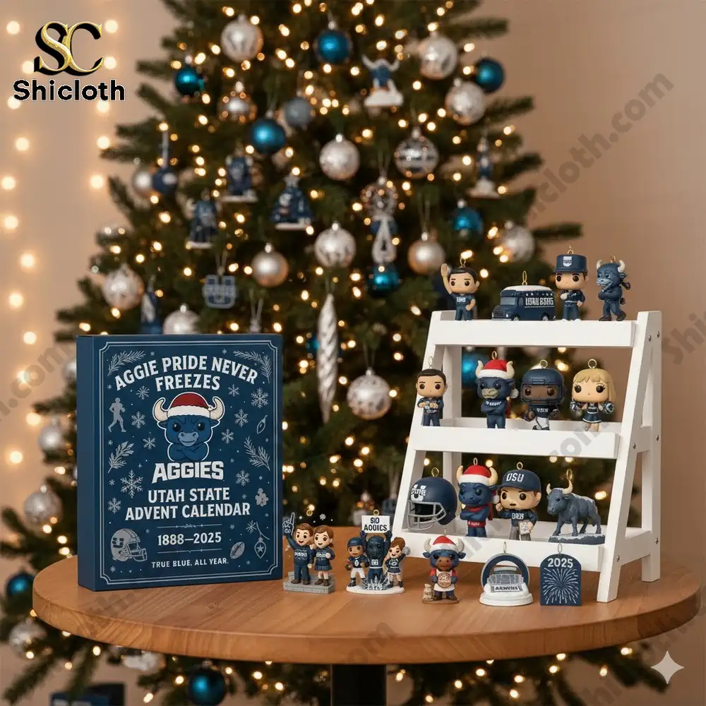 A Utah State Aggies Advent Calendar 2025 display with blue themed figurines in front of a decorated Christmas tree.