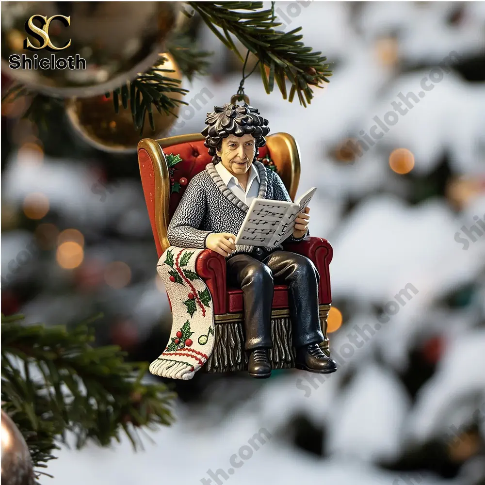 Visions of Christmas Premium Advent Calendar 2025 4 A Christmas tree ornament of a figure reading sheet music while sitting on a red chair.