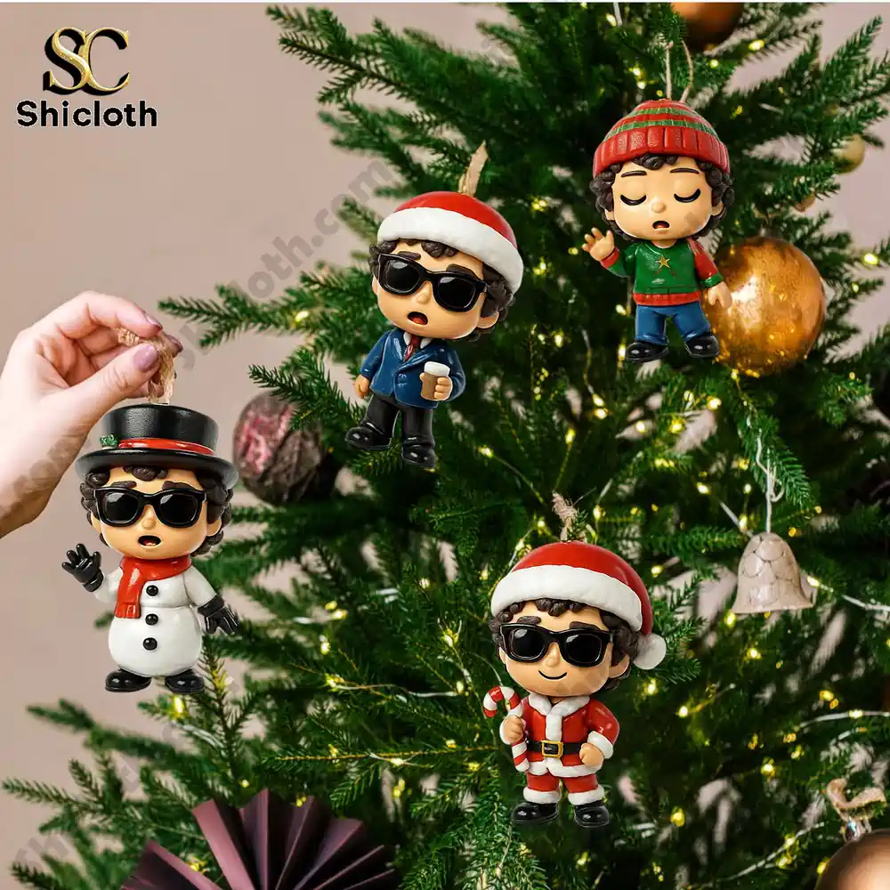 Visions of Christmas Premium Advent Calendar 2025 5 Four small Christmas ornaments with festive outfits hanging on a Christmas tree.