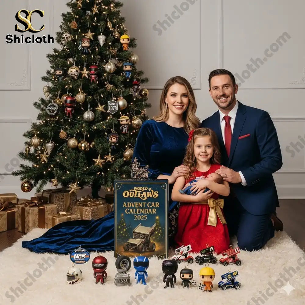 A smiling family poses in front of a Christmas tree with the World of Outlaws Advent Car Calendar 2025 and miniature race car figures arranged on a white carpet!