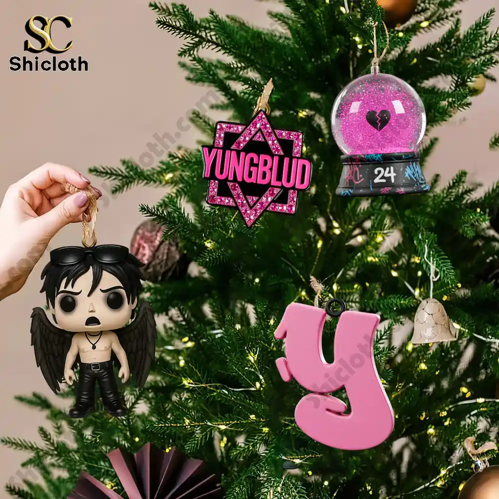 Yungblud Merry Christmas Advent Calendar 2025 5 A hand hanging Yungblud themed ornaments on a decorated Christmas tree.