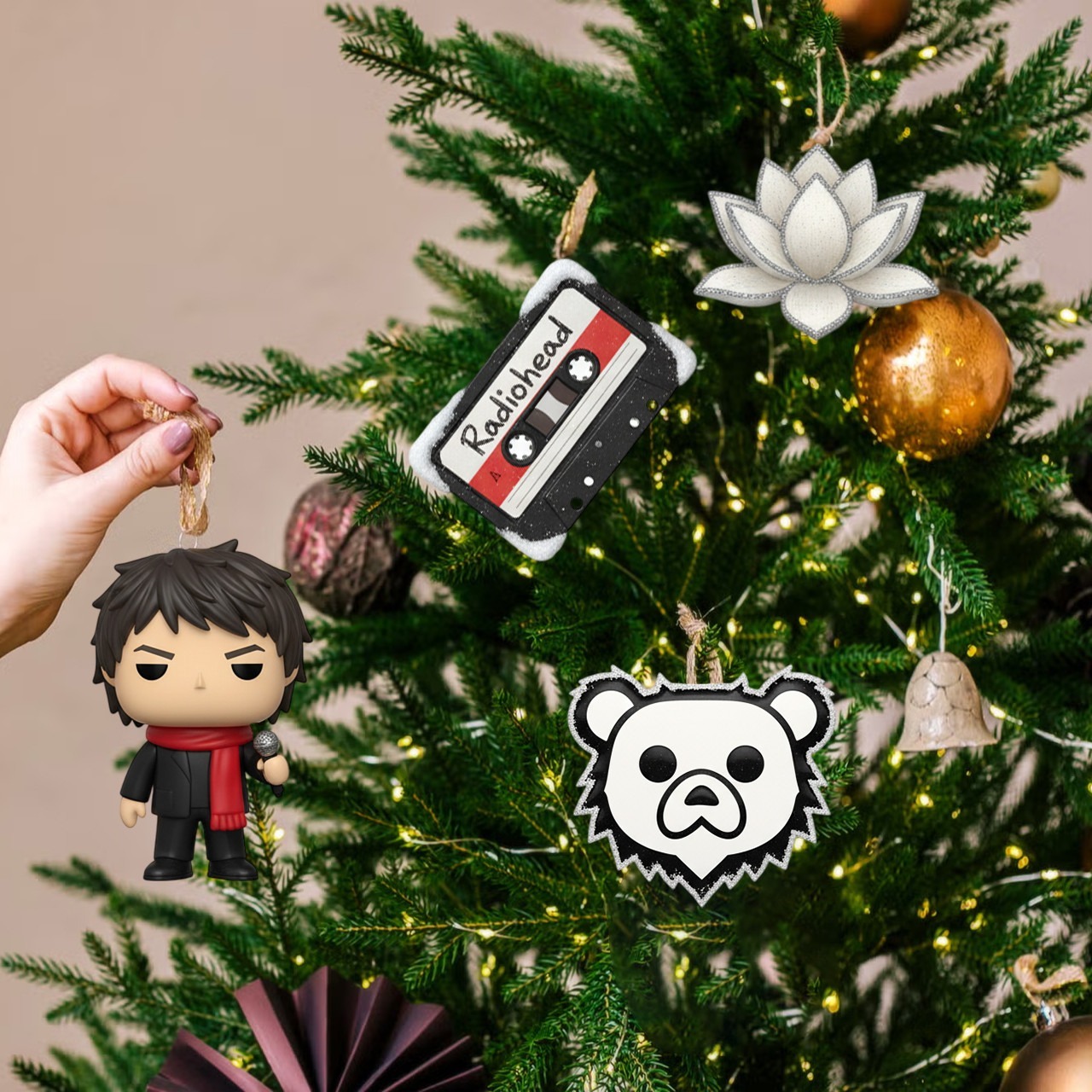 Radiohead Premium Advent Calendar 2025 4 Radiohead-themed Christmas ornaments, including the bear logo, cassette, and singer figure, hanging on a Christmas tree.