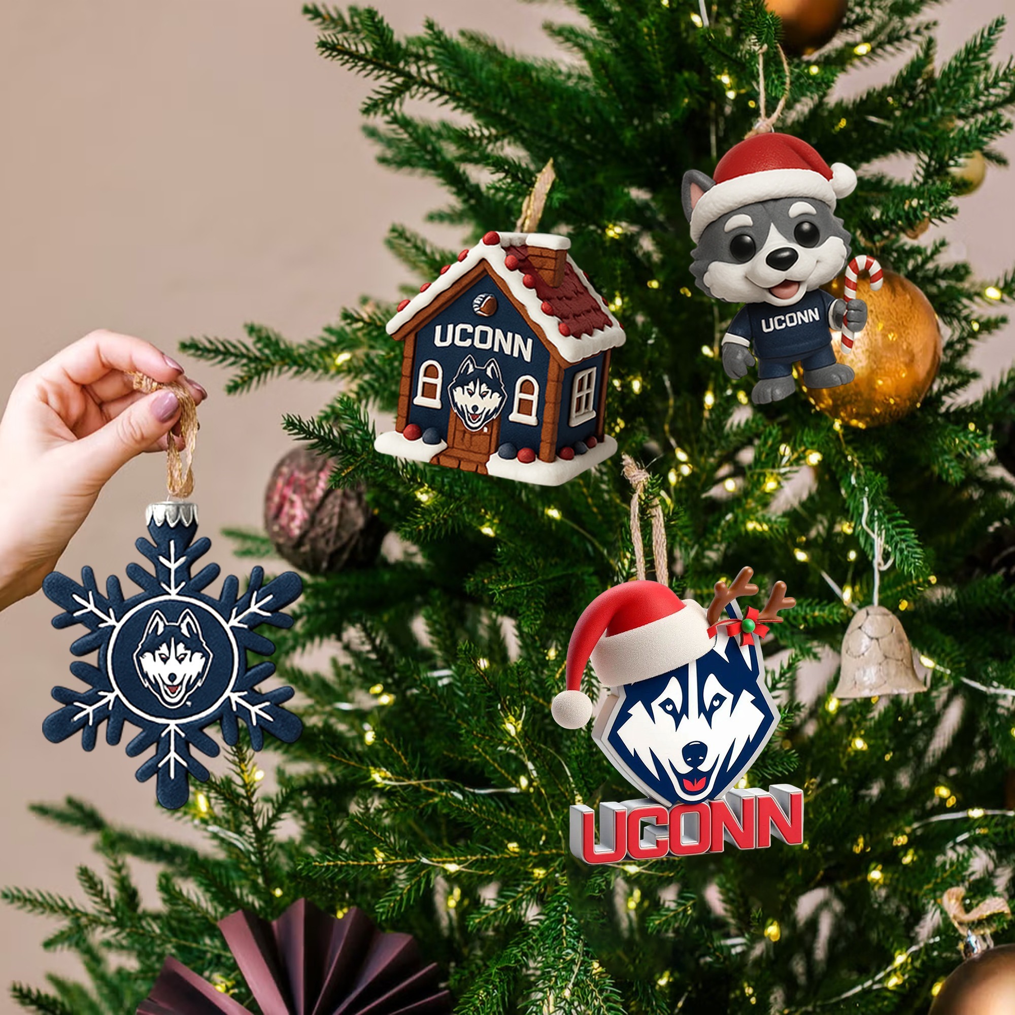 Uconn Huskies Advent Calendar 2025 4 UConn Huskies Christmas ornaments, including the mascot and house, hanging on a decorated Christmas tree.