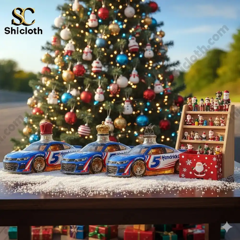 Three Hendrick Motorsports number 5 race car whiskey bottles displayed on a table in front of a decorated Christmas tree.