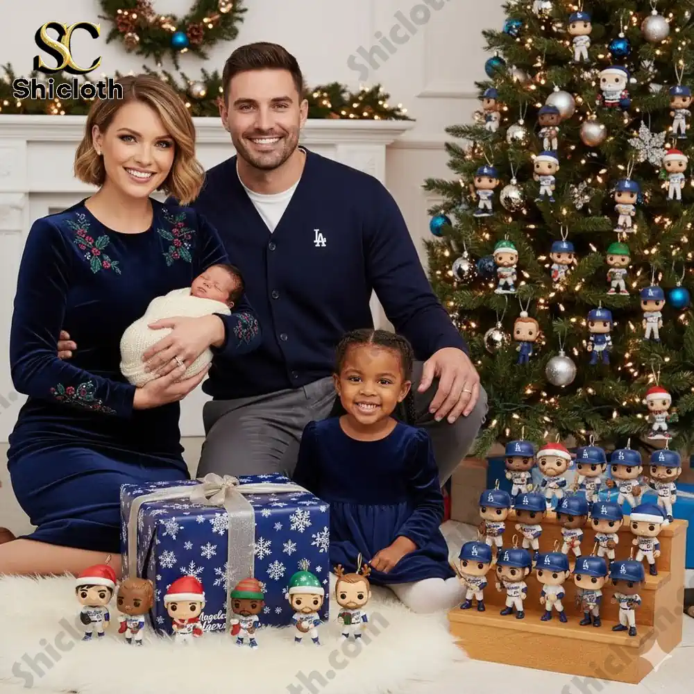 A smiling family poses by a Christmas tree decorated with Los Angeles Dodgers figures and gifts.