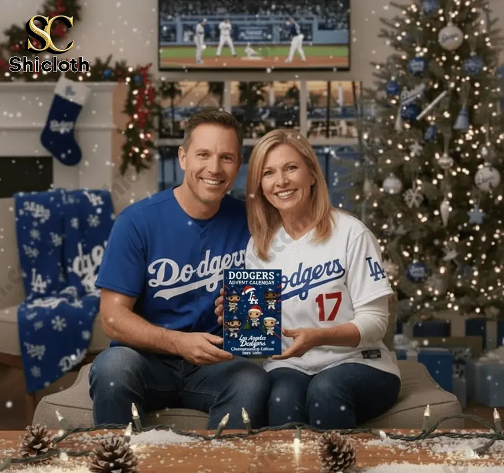 2025 LA Dodgers Championship Advent Calendar 3 A smiling couple holds a Los Angeles Dodgers Advent Calendar beside a decorated Christmas tree.