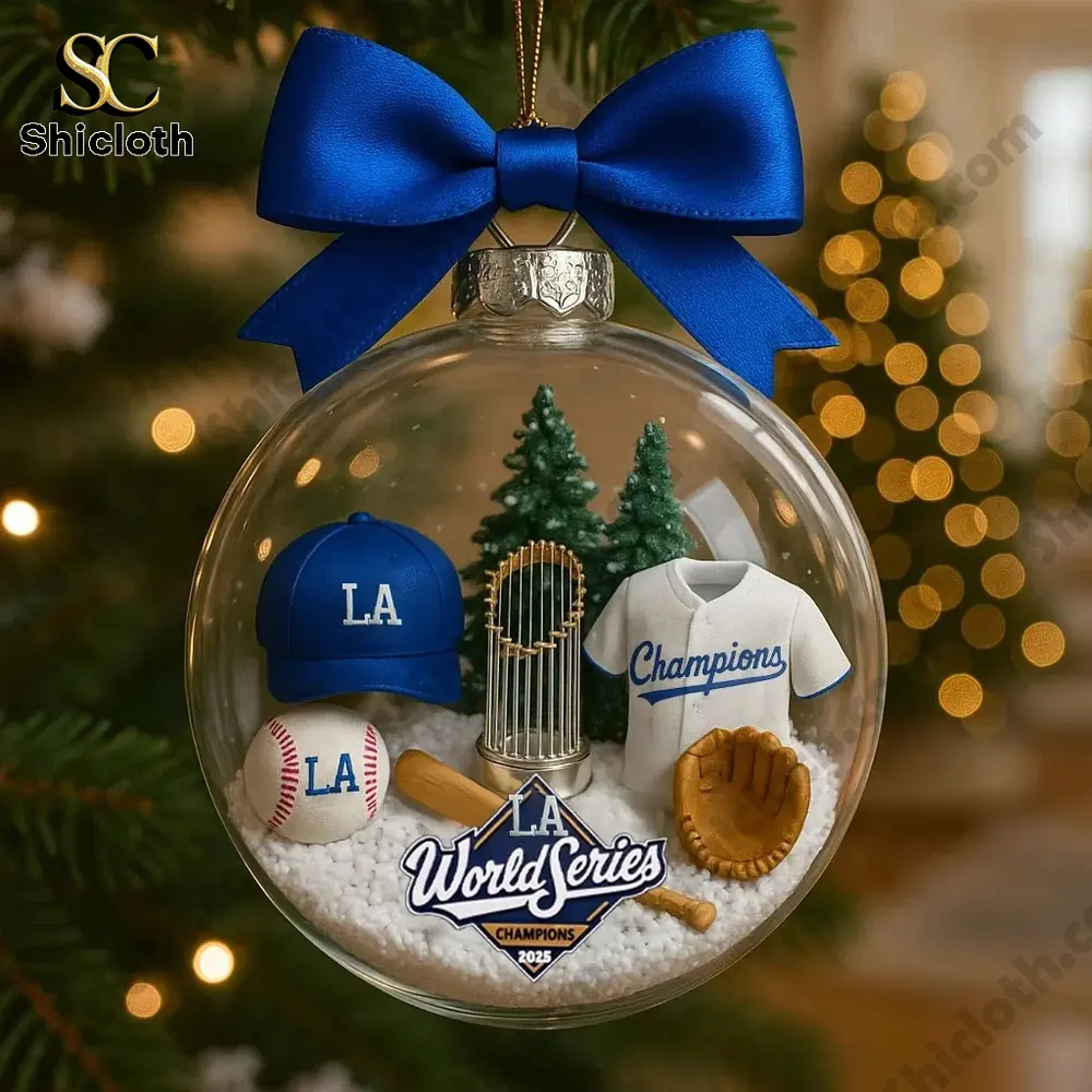 Clear ornament with baseball themed mini items hanging on a Christmas tree.