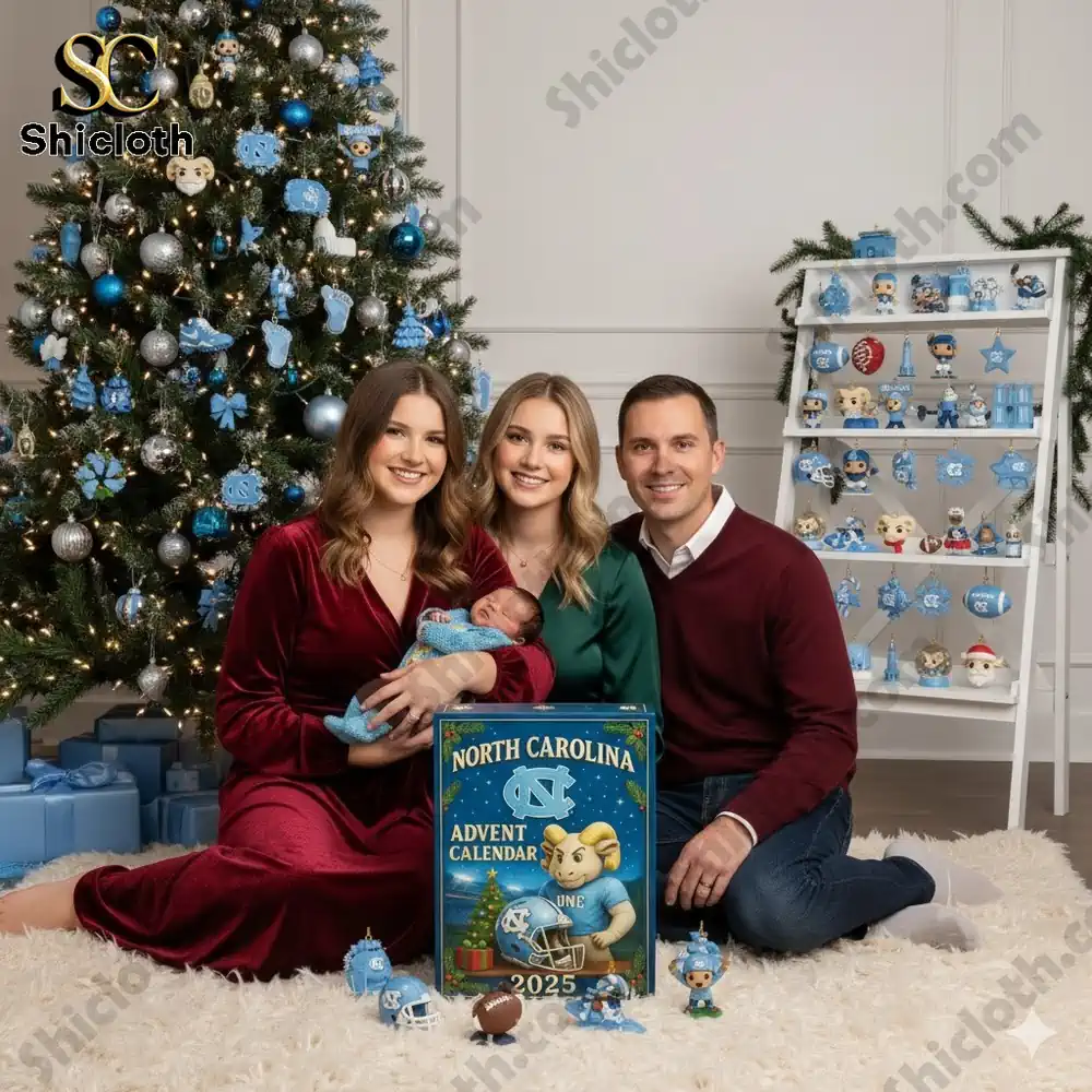 A family posing with a North Carolina 2025 advent calendar and a Christmas tree decorated in blue and silver ornaments.