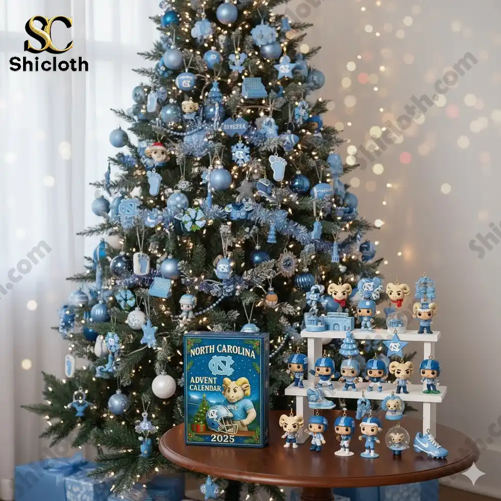 A Christmas tree with blue and silver North Carolina decorations and the 2025 advent calendar displayed on a table.