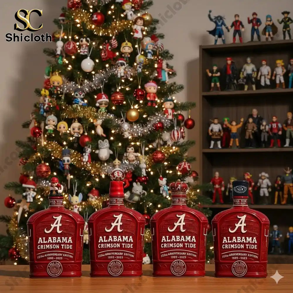 Four Alabama Crimson Tide anniversary bottles displayed in front of a decorated Christmas tree.