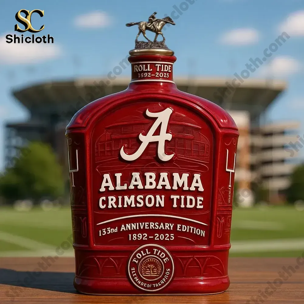 Alabama Crimson Tide anniversary bottle with rider topper displayed outdoors near a stadium.