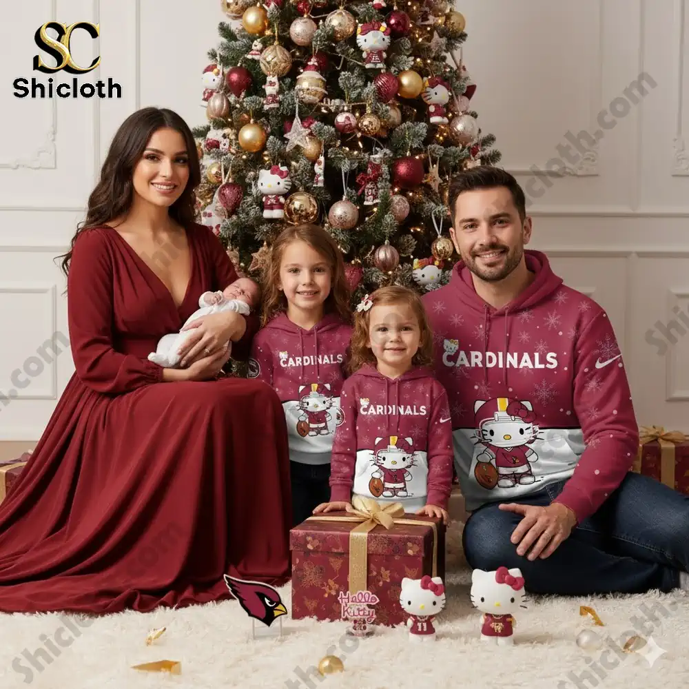 A family of four dressed in Hello Kitty themed Arizona Cardinals hoodies celebrating Christmas under a festive tree.