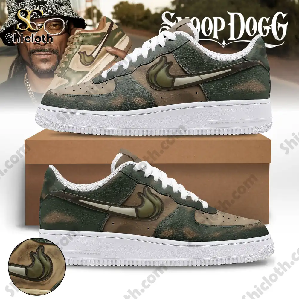 Green camouflage shoes displayed with a man in a hat blurred in the background!