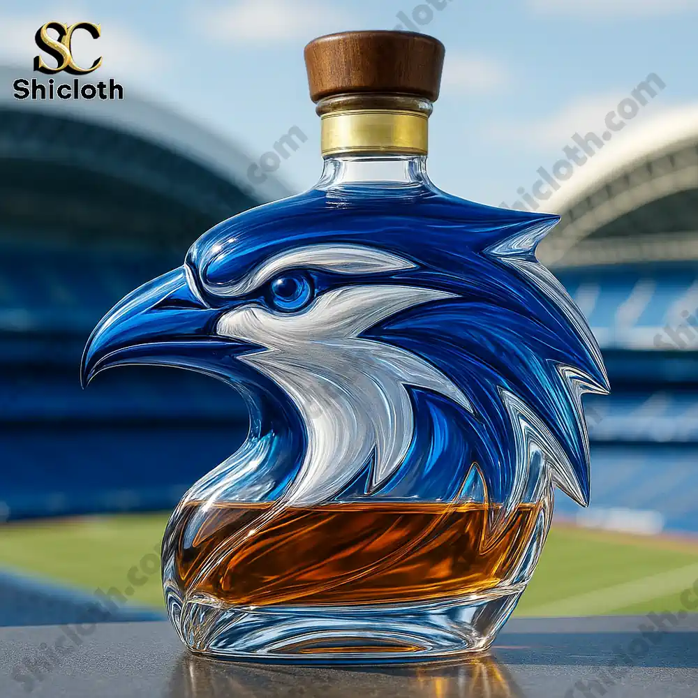 A single blue eagle shaped liquor bottle displayed in an outdoor stadium setting.