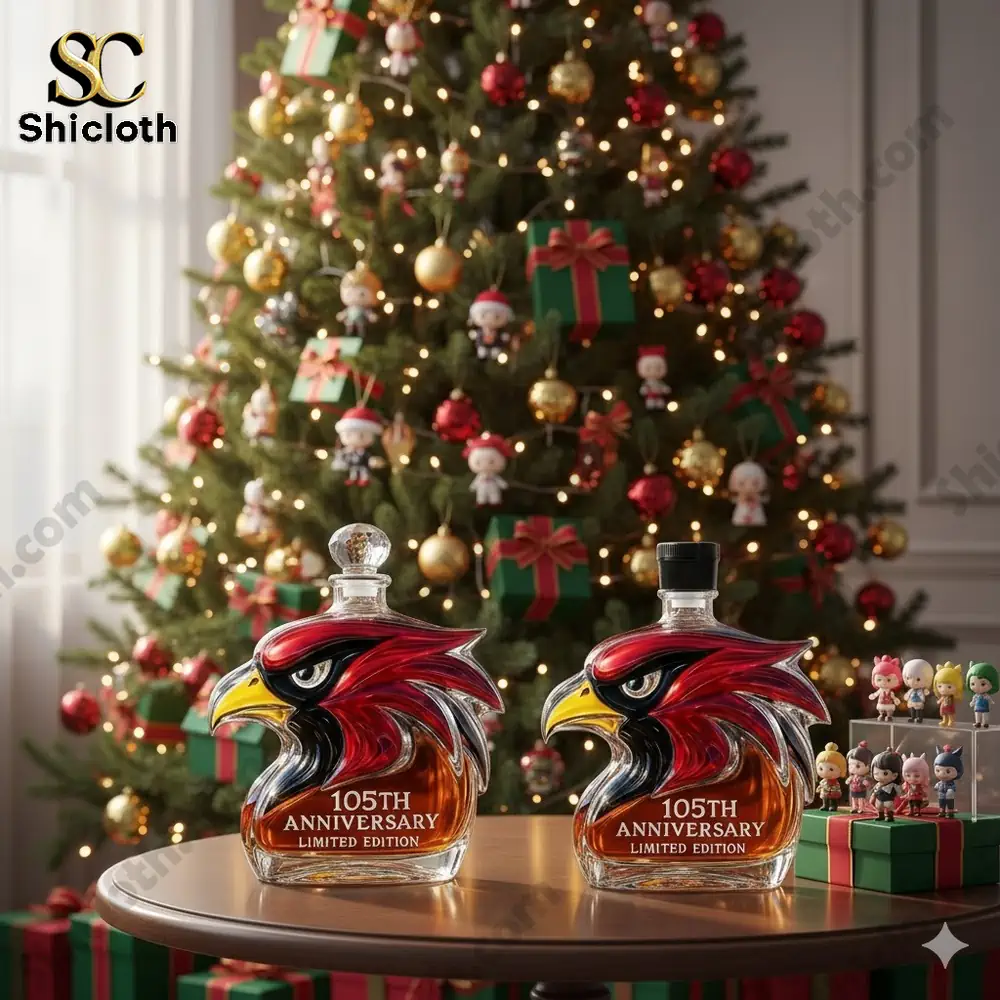 Two cardinal shaped anniversary bottles displayed on a table in front of a decorated Christmas tree.